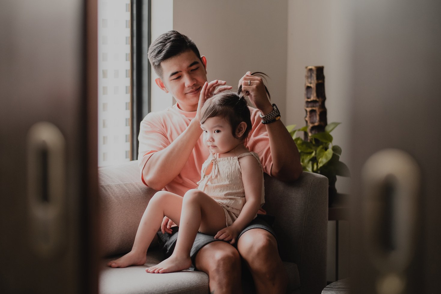 Father Tying Daughter's Hair