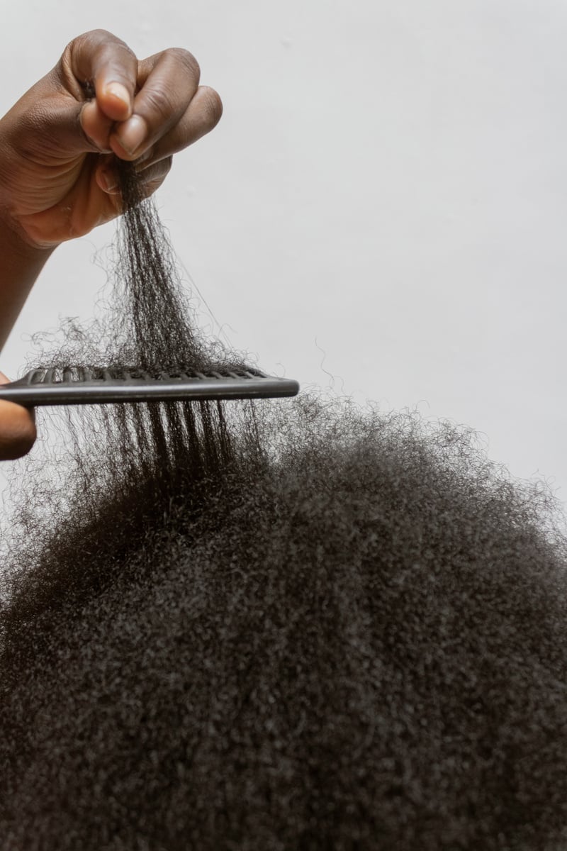 Person Combing Curly Hair