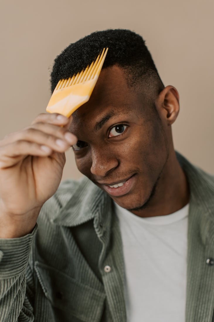 Man with Hair Pick Combing Curly Hair