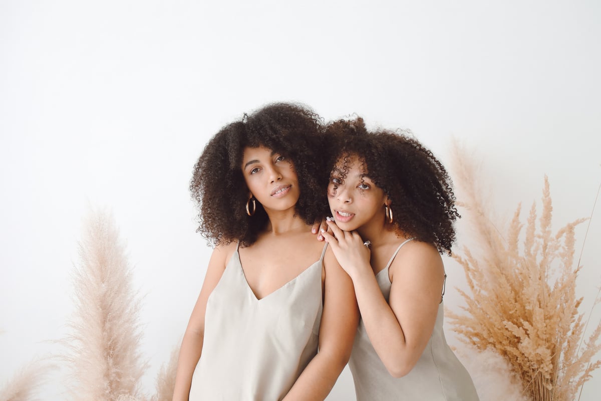 Curly Haired Women Posing Together